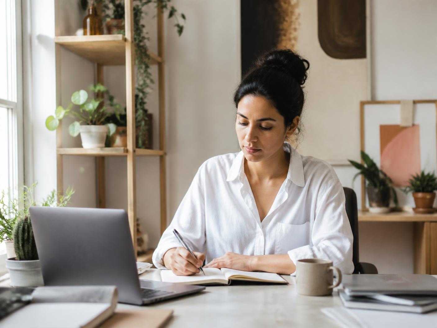 Freelancer planning her workday at a calm home studio desk